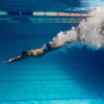 underwater picture of male swimmer swimming i swimming pool